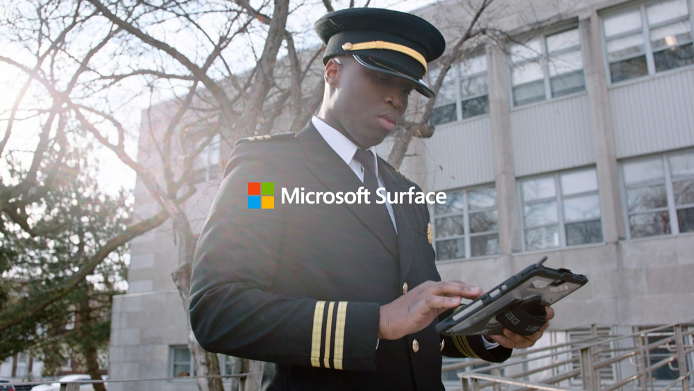 A government worker using touch on his Surface Pro device on the move.